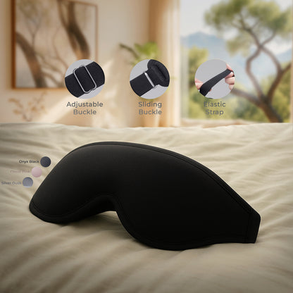 Black sleep mask on a bed with close-up details of buckles and straps.